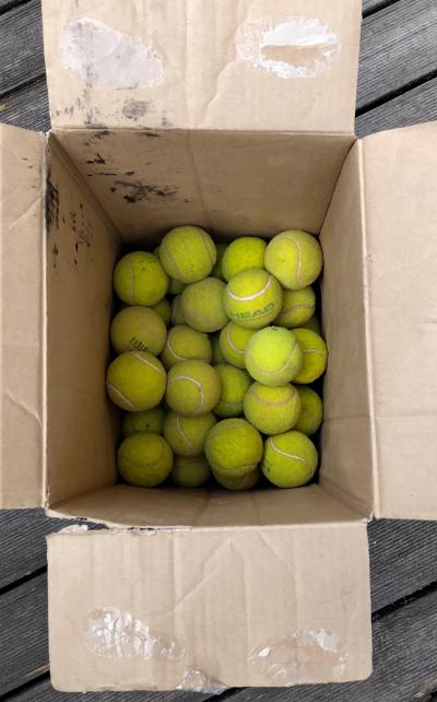 Půl krabice tenisových míčků