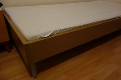 Téměř nepoužívaná postel s matrací a roštem.